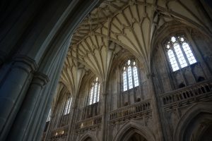 The ornate ceiling and high windows of the cathedral in Winchester, England.