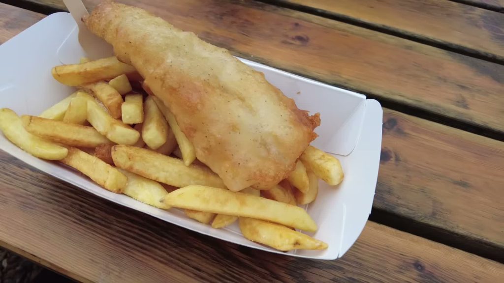 Battered fish and chips in a tray