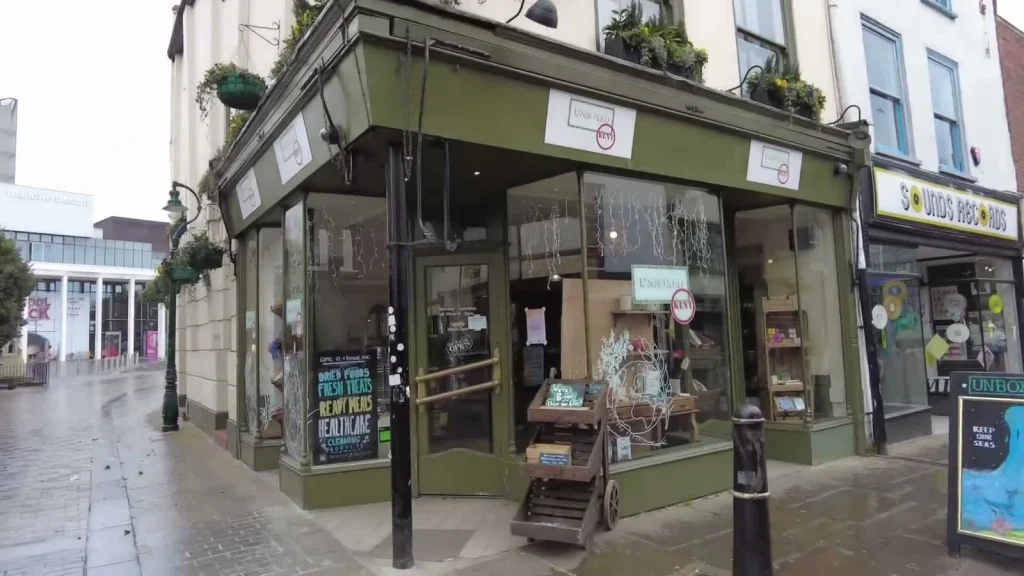 The green shopfront of Unboxed Kent in Canterbury, with refill products advertised by the entrance.