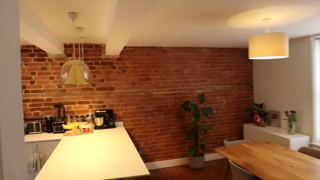 Kitchen counter and dining table beside an exposed-brick wall in my Kent flat