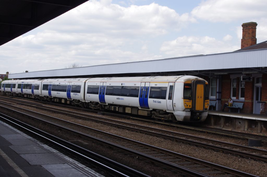A white Southeastern train with blue doors beside a platform at Tonbridge station
