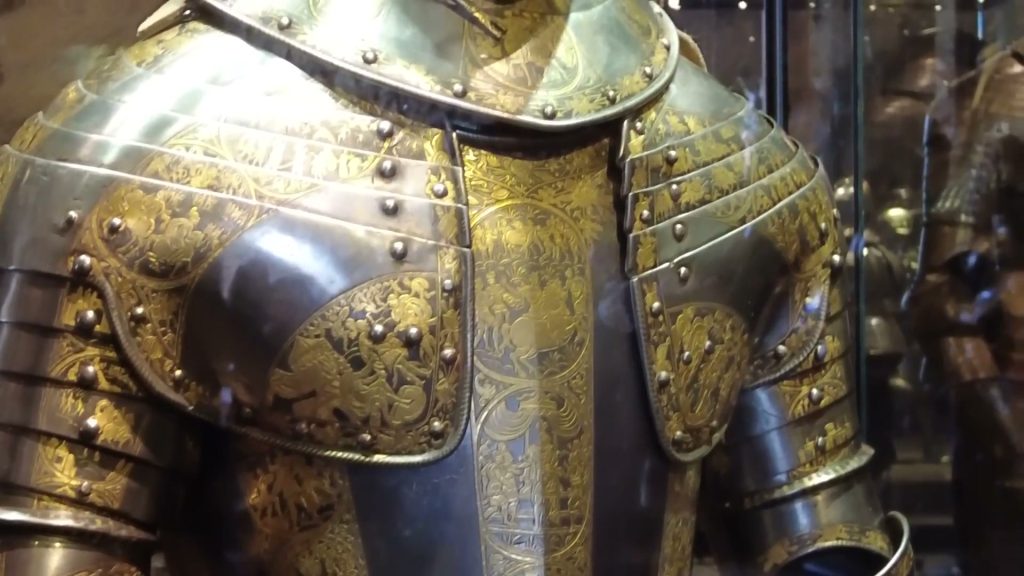 Gold floral decoration across the breastplate and shoulders of Prince Henry's armour.