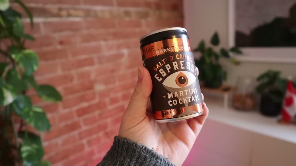 A hand holding an M&S Marksologist salted caramel espresso martini can.
