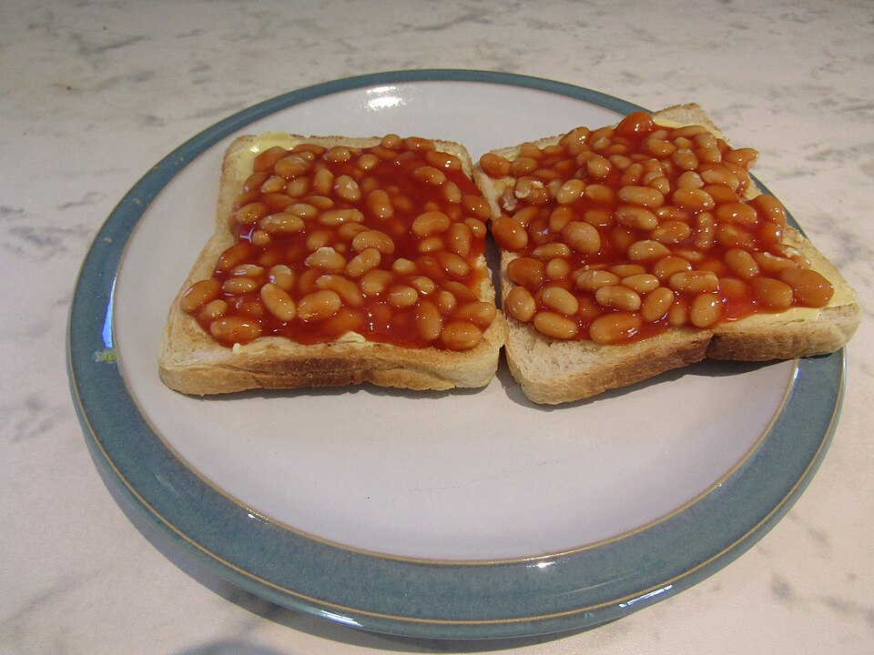 Baked beans in tomato sauce on two slices of toast on a plate.