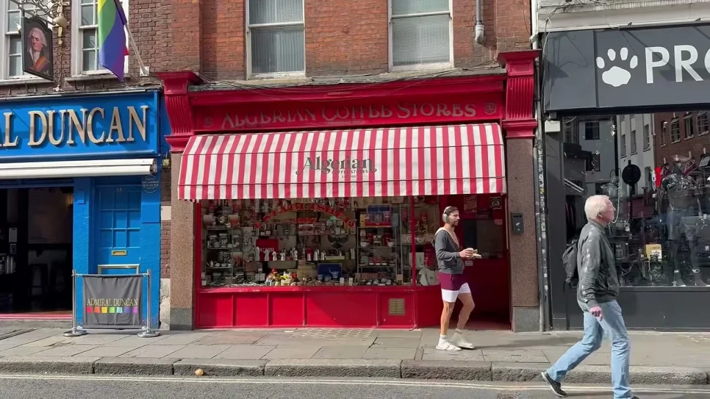 The red Algerian Coffee Stores shopfront beneath a red and white striped awning.