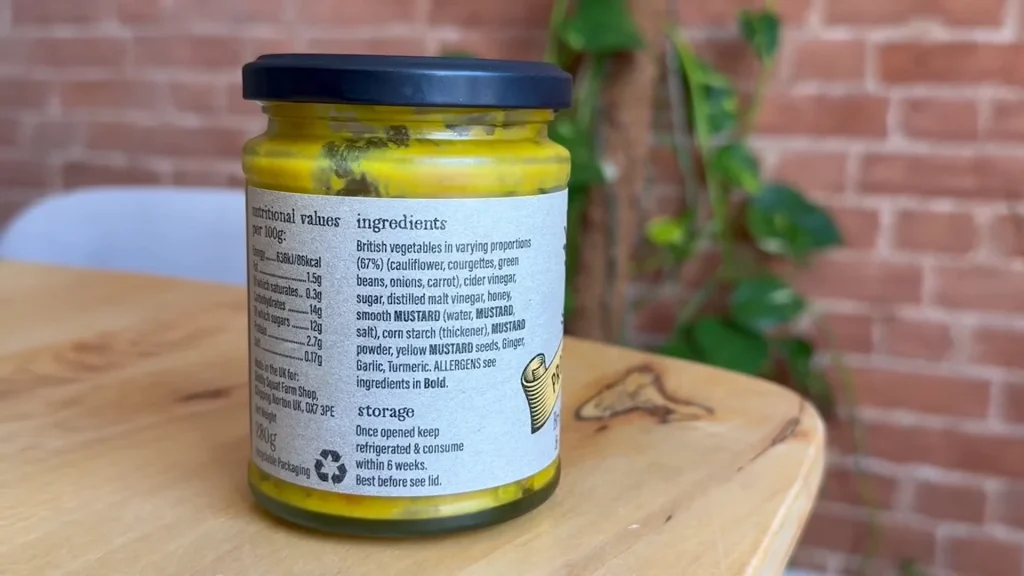Close view of the Diddly Squat Farm piccalilli jar, showing the listed British vegetables and mustard ingredients.